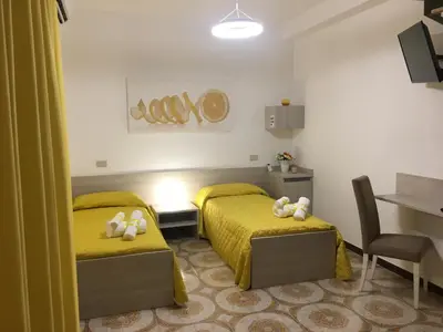 a bedroom with two beds with teddy bears on them at Alto Giardino Rooms in Terrasini