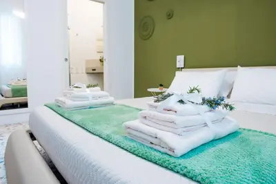 a pile of towels sitting on top of a bed at CIELO D' ALCAMO Palazzo Adamo in Alcamo