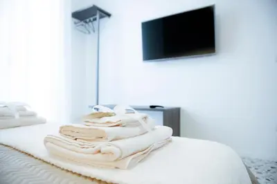 a pile of towels sitting on top of a bed at CIELO D' ALCAMO Palazzo Adamo in Alcamo