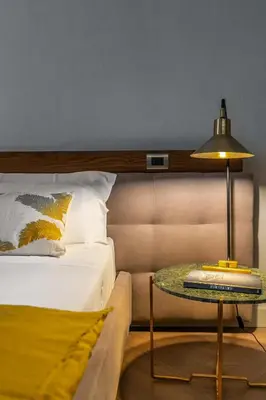 a bedroom with a bed and a table with a lamp at InCanto in Palermo