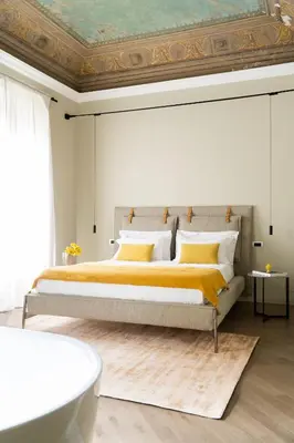 a bedroom with a large bed and a bath tub at InCanto in Palermo