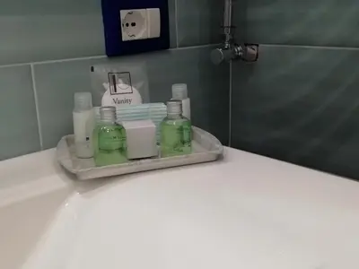 a shelf with glass bottles on a counter in a bathroom at LOFT 99 in Palermo