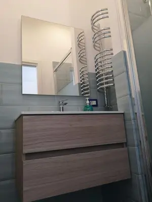 a bathroom with a sink and a mirror at LOFT 99 in Palermo