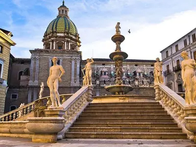 a fountain in front of a building with a tower at LOFT 99 in Palermo