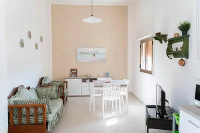 a living room with a table and a couch at Villa Claudia e Simone in Carini