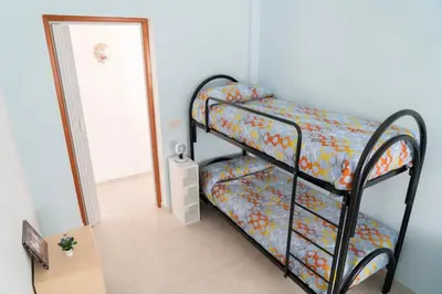 a bedroom with two bunk beds in a room at Villa Claudia e Simone in Carini