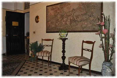 a room with two chairs and a painting on the wall at Bed and Breakfast D'Angelo in Palermo