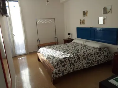 a bedroom with a bed with a blue headboard at I Cavalieri di Malta in Palermo