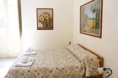 a bedroom with a bed and a picture on the wall at I Cavalieri di Malta in Palermo