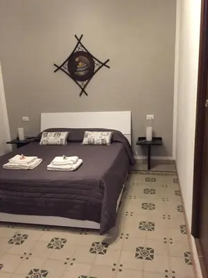a bedroom with a bed with two towels on it at BONORUM in Palermo