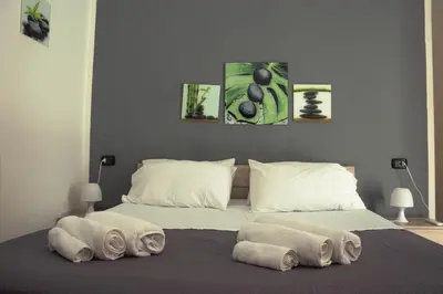 a bedroom with a bed with towels on it at BONORUM in Palermo