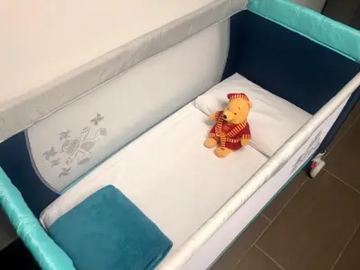 a small teddy bear sitting on a bed at La Caletta Casa Vacanze, PRIVATE POOL in Terrasini