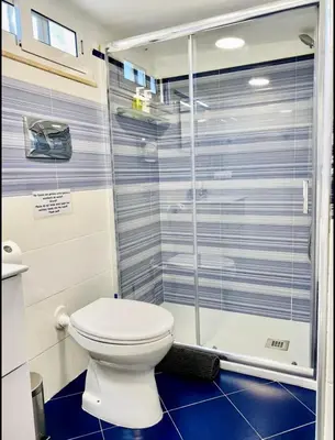 a bathroom with a toilet and a shower at La Caletta Casa Vacanze, PRIVATE POOL in Terrasini