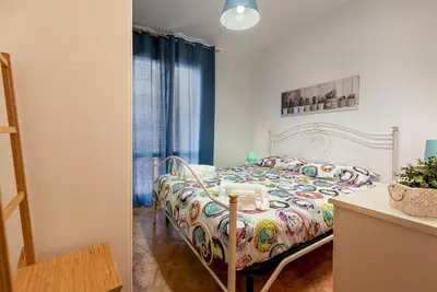 a bedroom with a bed with a colorful comforter at Carlottas Home in San Vito lo Capo