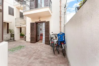 two bikes parked against a wall in front of a building at Carlottas Home in San Vito lo Capo