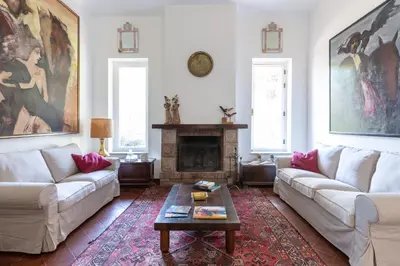 a living room with two couches and a fireplace at Il Giardino di Michela by DomuSicily in Mondello