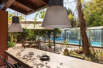 a patio with a table and chairs and a pool at Il Giardino di Michela by DomuSicily in Mondello