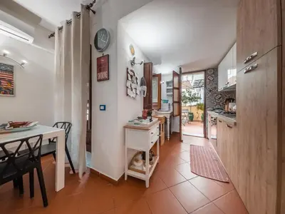 a kitchen and dining room with a table and a counter at Casa Ruggiero in Palermo