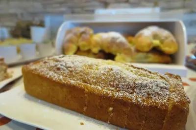 a loaf of bread on a plate with pastries in the background at Trigrana Vacanze Hotel in Castelluzzo