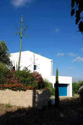a white house with a view of trees at casa zabbara in Balestrate