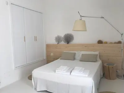 a living room with a white couch with pillows at casa zabbara in Balestrate