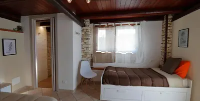 a small bedroom with a bed and a window at Villa Araucaria in Partinico
