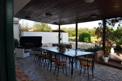 a patio with white chairs and a table and a white table and chairs at Corso's old nest a mille metri dalla spiaggia guida loca in Castellammare del Golfo