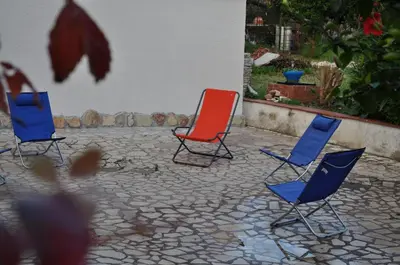 a group of chairs and a table on a patio at Corso's old nest a mille metri dalla spiaggia guida loca in Castellammare del Golfo