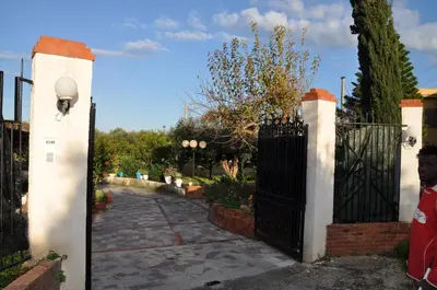 a garden with a brick path and a street light at Corso's old nest a mille metri dalla spiaggia guida loca in Castellammare del Golfo