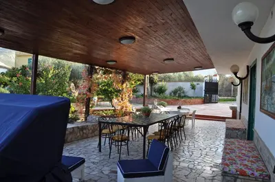 a kitchen with a table with a bowl of oranges on it at Corso's old nest a mille metri dalla spiaggia guida loca in Castellammare del Golfo