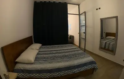 a small bedroom with a bed and a mirror at La Casetta delle Scienze in Palermo