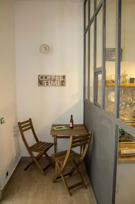 a table and two chairs next to a window at La Casetta delle Scienze in Palermo