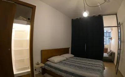 a bedroom with a bed with a black curtain at La Casetta delle Scienze in Palermo