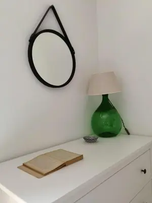 a table with a lamp and a mirror on it at Il terrazzino sul Kemonia in Palermo