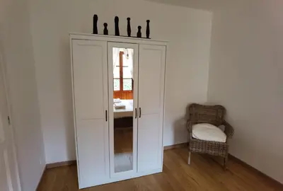 a white cabinet in a room with a chair at Il terrazzino sul Kemonia in Palermo