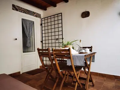 a dining room with a table and two chairs at Il terrazzino sul Kemonia in Palermo