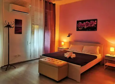 a bedroom with a bed and a chair in it at A un passo dal centro in Palermo