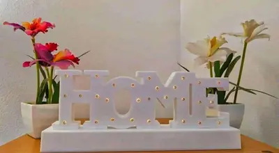a white sign that says love with flowers at A un passo dal centro in Palermo
