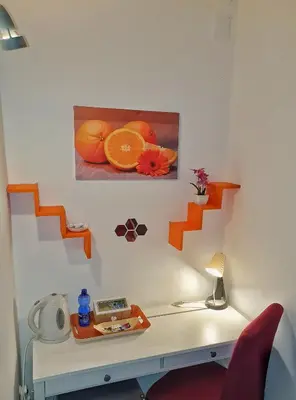 a room with a desk with a picture of oranges at A un passo dal centro in Palermo