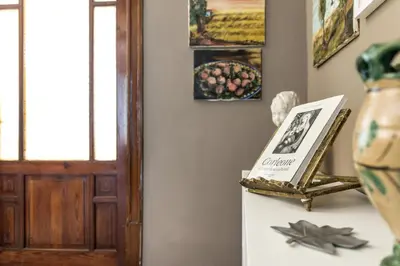 a hallway with a door and a table with a vase at SUITE S.LUCIA in Corleone