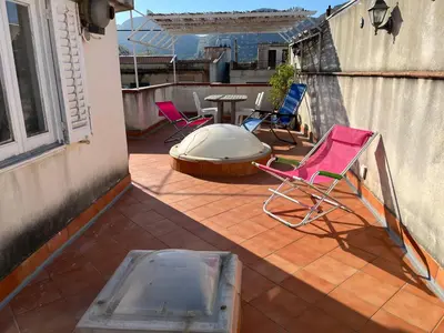 a patio with chairs and a table on a balcony at Da Sophie in Mondello