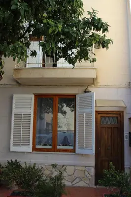 a house with a window and a wooden door at Da Sophie in Mondello
