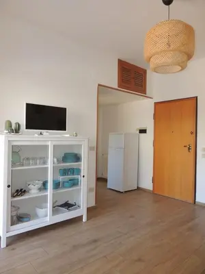 a kitchen with a white cabinet and a refrigerator at La Locanda del Cedro in Palermo