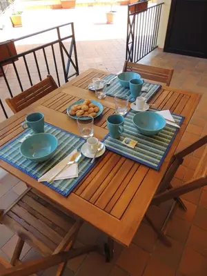 a wooden table with plates of food on it at La Locanda del Cedro in Palermo