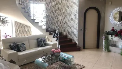 a living room with a white couch and a staircase at Villa Grisì in Partinico
