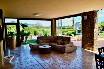a living room with a couch and a table at Villa Grisì in Partinico