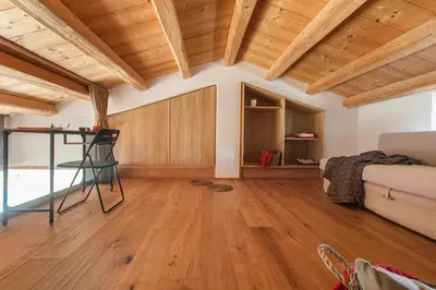 a living room with wooden ceilings and wooden floors at Casa Saleiman in Castellammare del Golfo