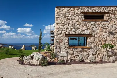 a stone building with a window on the side of it at Casa Saleiman in Castellammare del Golfo