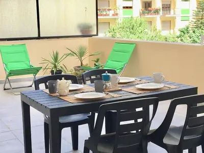 a wooden table with chairs and plates on it at Residenza De Gasperi in Palermo