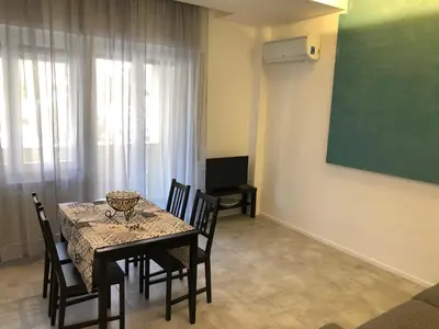 a dining room with a table and chairs and a greenboard at Residenza De Gasperi in Palermo